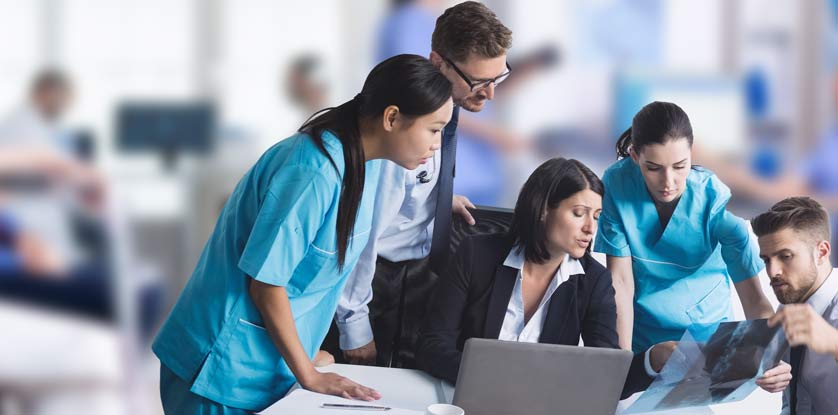 medical team examining x-ray report